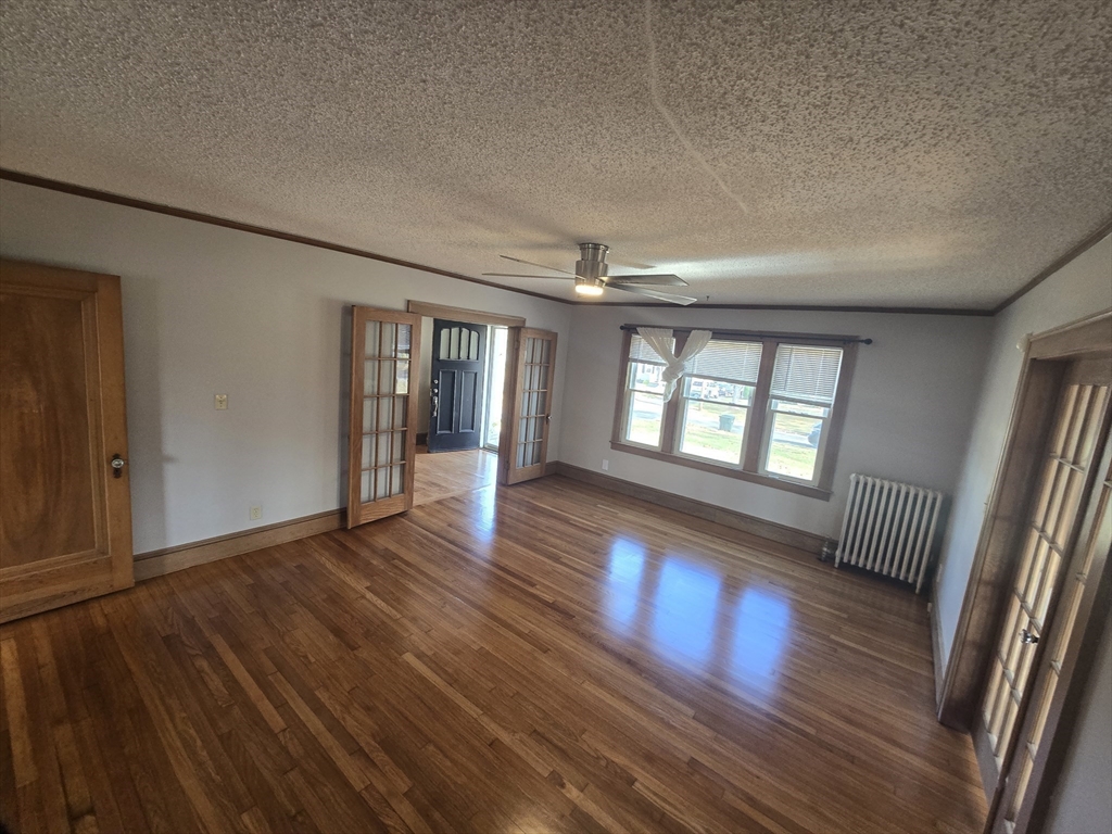 40 Catalpa Terrace Springfield, MA 01119 - Photo 6 of 24 a view of an empty room with wooden floor and a window