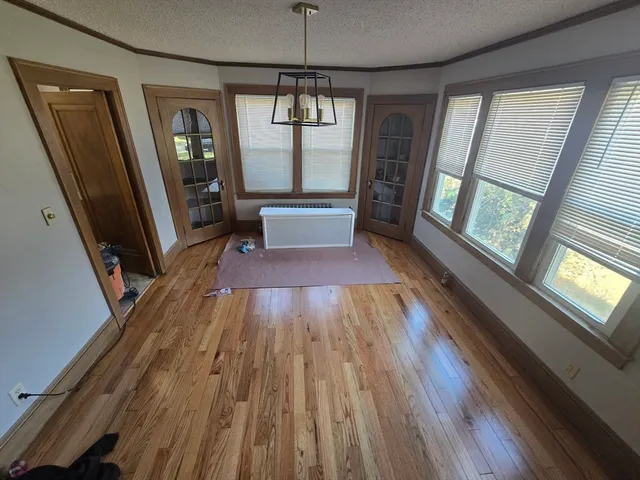 a view of a room with wooden floor and windows