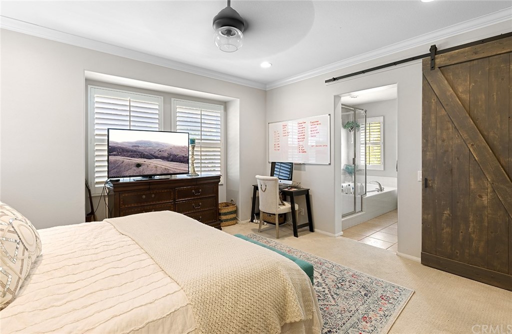 6 Pomegranate Street Ladera Ranch, CA 92694 - Photo 15 of 40 a bedroom with a bed and a chandelier