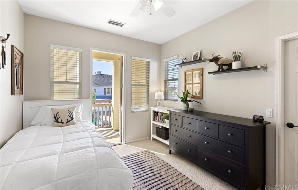 6 Pomegranate Street Ladera Ranch, CA 92694 - Photo 22 of 40 a bedroom with a bed and a table in it