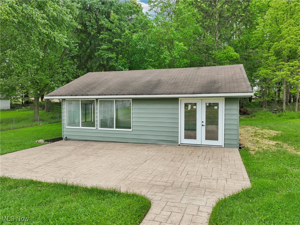 13225 Bagley Road Cleveland, OH 44130 - Photo 36 of 50 Rear view of property featuring a shingled roof, a patio area, and a lawn