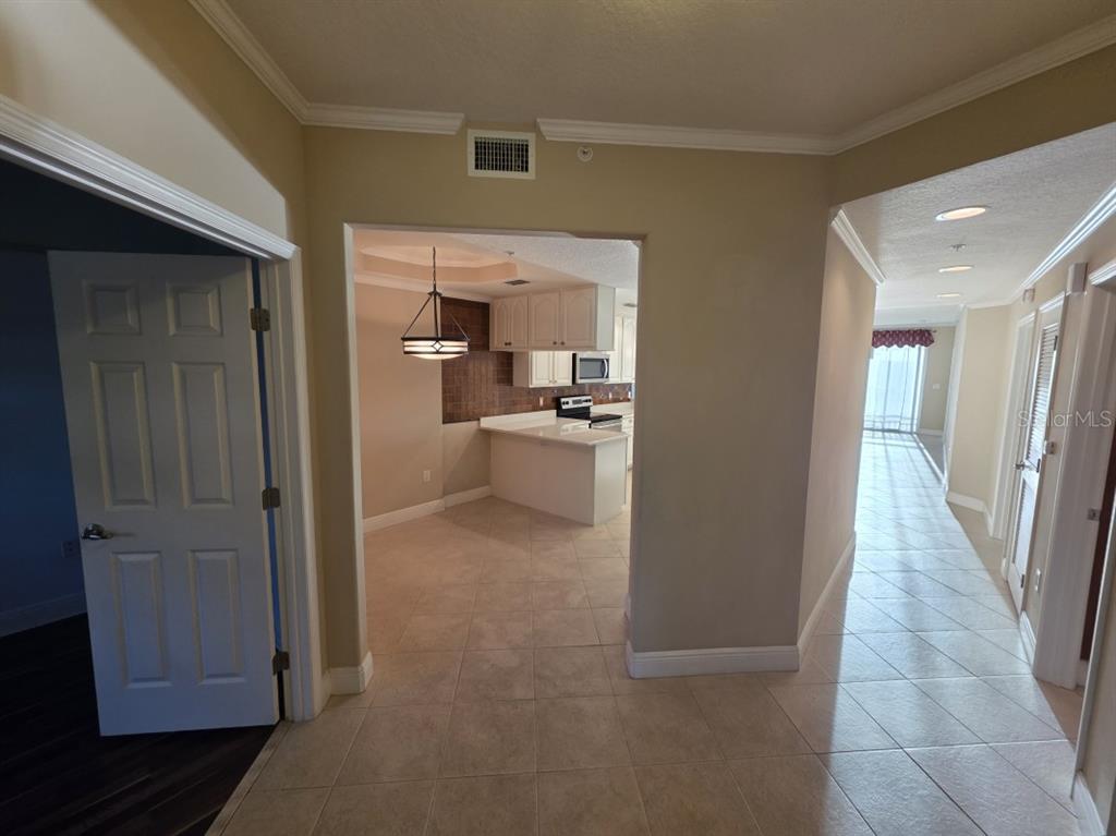 7070 Key Haven Road, Unit 402 Seminole, FL 33777 - Photo 11 of 34 a view of a hallway with wooden floor and cabinet