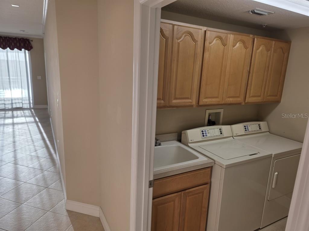 7070 Key Haven Road, Unit 402 Seminole, FL 33777 - Photo 16 of 34 a utility room with dryer and washer
