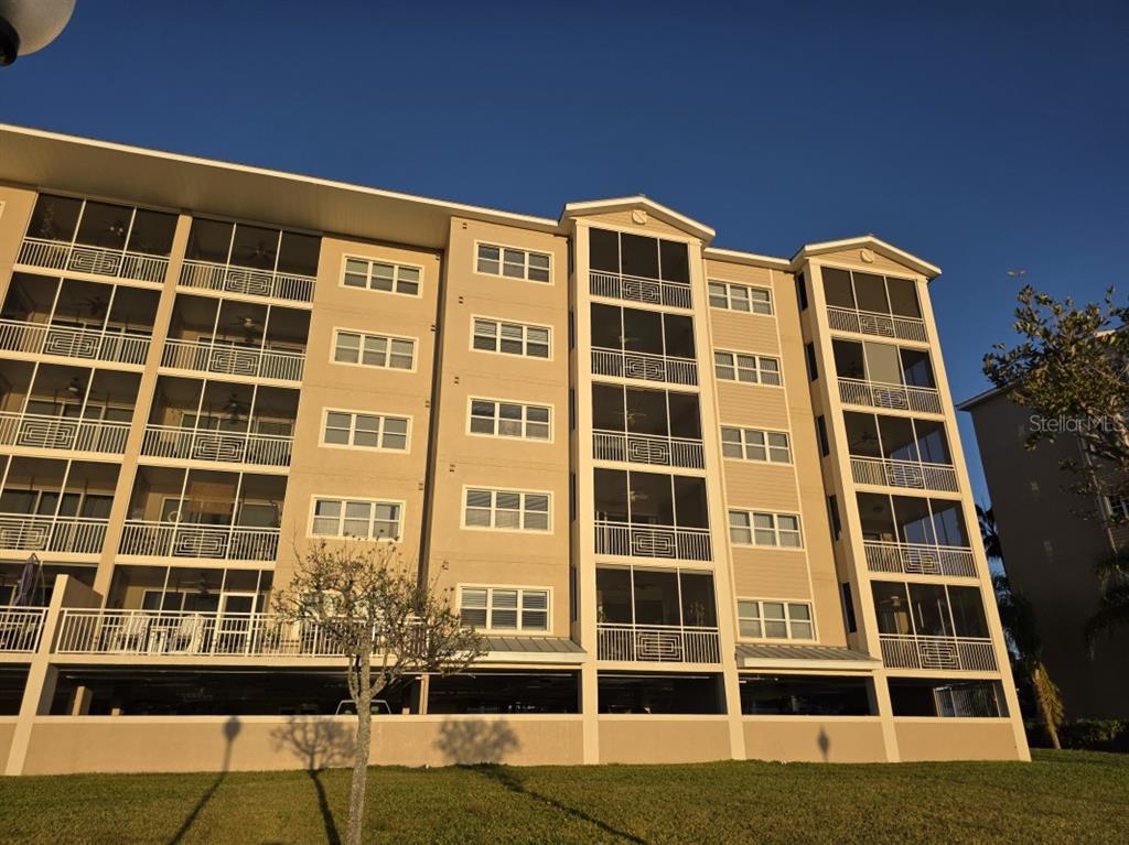 7070 Key Haven Road, Unit 402 Seminole, FL 33777 - Photo 2 of 34 a front view of a building with a yard