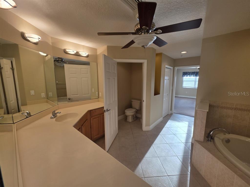 7070 Key Haven Road, Unit 402 Seminole, FL 33777 - Photo 23 of 34 a bathroom with a tub a sink and mirror