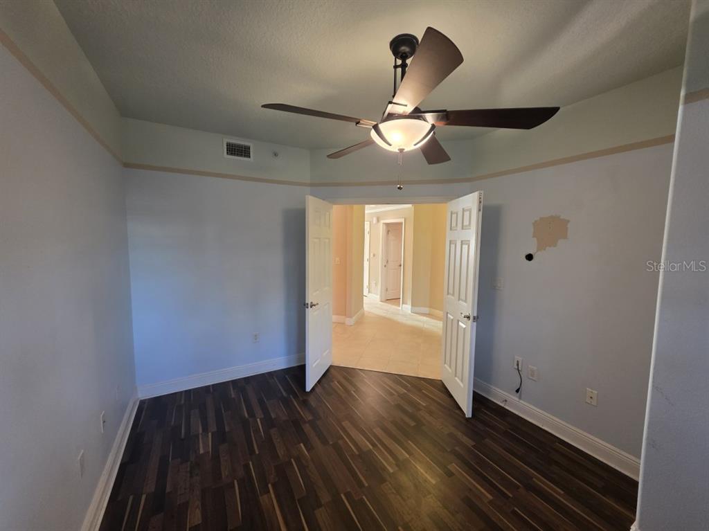 7070 Key Haven Road, Unit 402 Seminole, FL 33777 - Photo 33 of 34 a view of empty room with wooden floor and fan