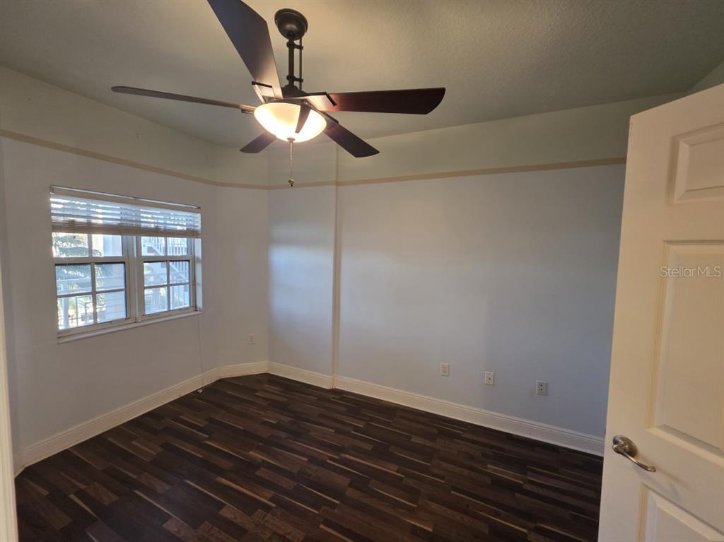 7070 Key Haven Road, Unit 402 Seminole, FL 33777 - Photo 34 of 34 a view of an empty room with wooden floor and a window