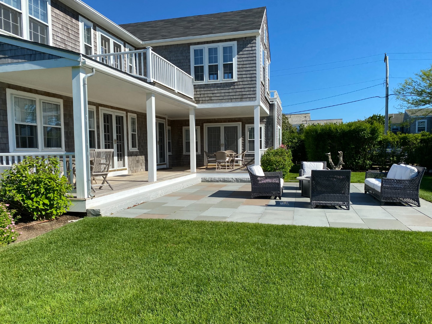 76 Baxter Road Nantucket, MA 02554 - Photo 6 of 25 a front view of a house with a garden and patio