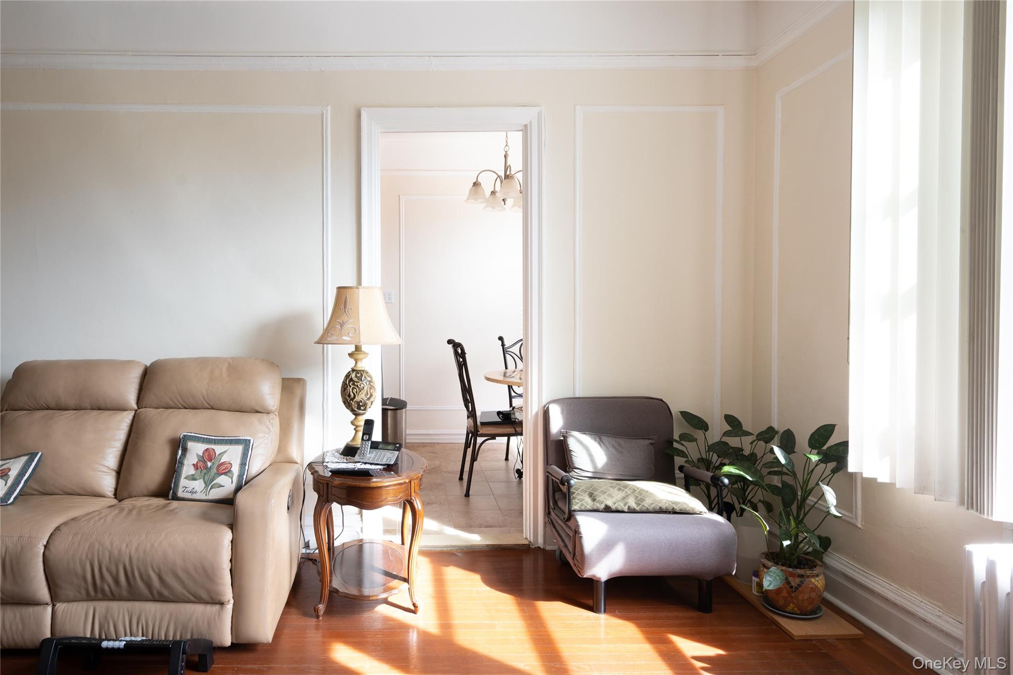 1468 Midland Avenue, Unit 4D Bronxville, NY 10708 - Photo 5 of 24 Living area with wood finished floors, radiator, and a chandelier