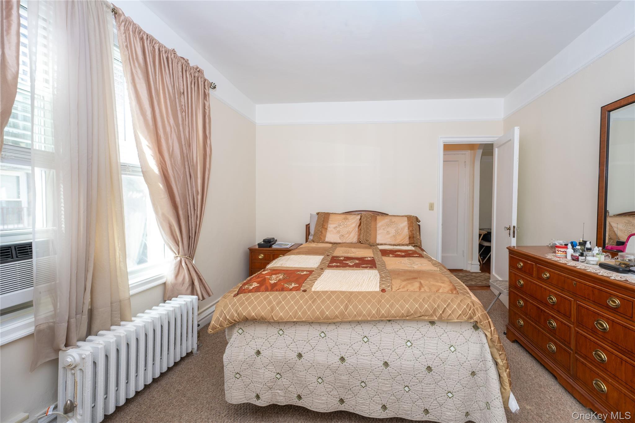1468 Midland Avenue, Unit 4D Bronxville, NY 10708 - Photo 9 of 24 Bedroom with radiator, carpet, and cooling unit