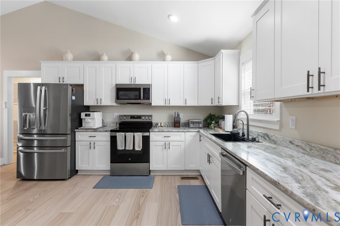 13545 Prince George Drive Disputanta, VA 23842 - Photo 6 of 18 Kitchen with stainless steel appliances, lofted ce