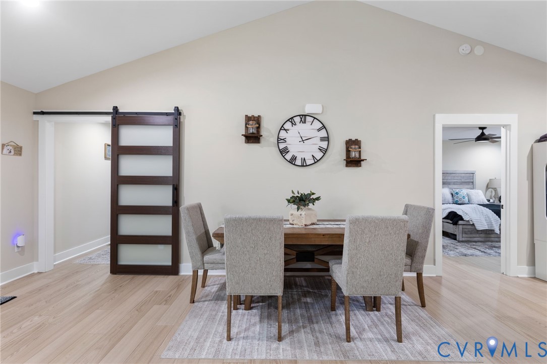 13545 Prince George Drive Disputanta, VA 23842 - Photo 7 of 18 Dining room featuring a barn door, lofted ceiling,