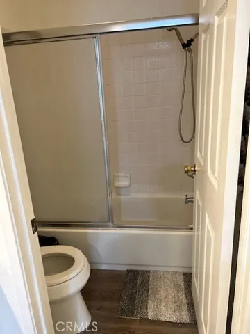 a bathroom with a shower and a toilet