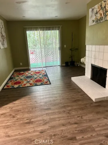 a living room with furniture rug and a fireplace