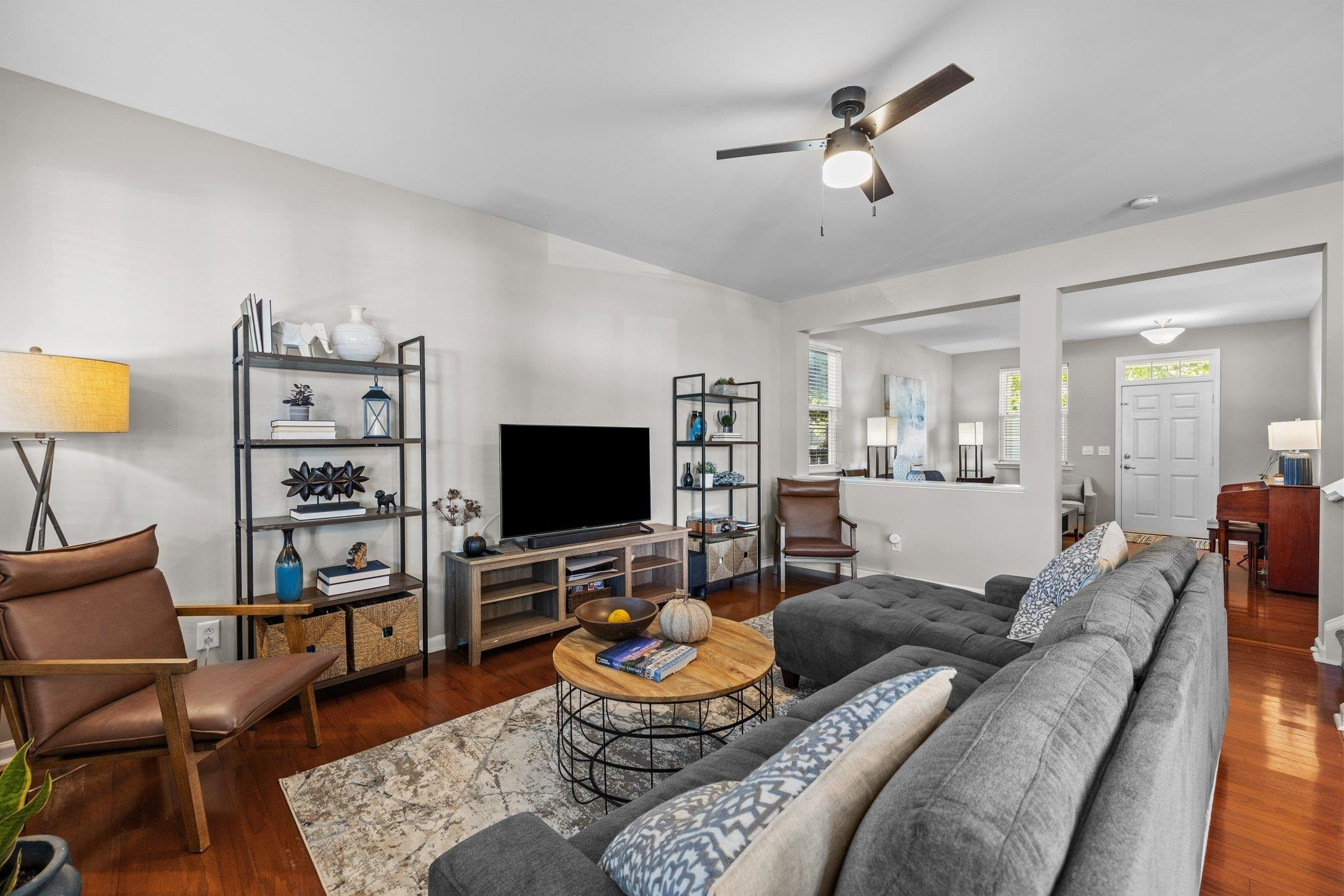 180 Solheim Lane Raleigh, NC 27603 - Photo 13 of 39 a living room with furniture and a flat screen tv with wooden floor