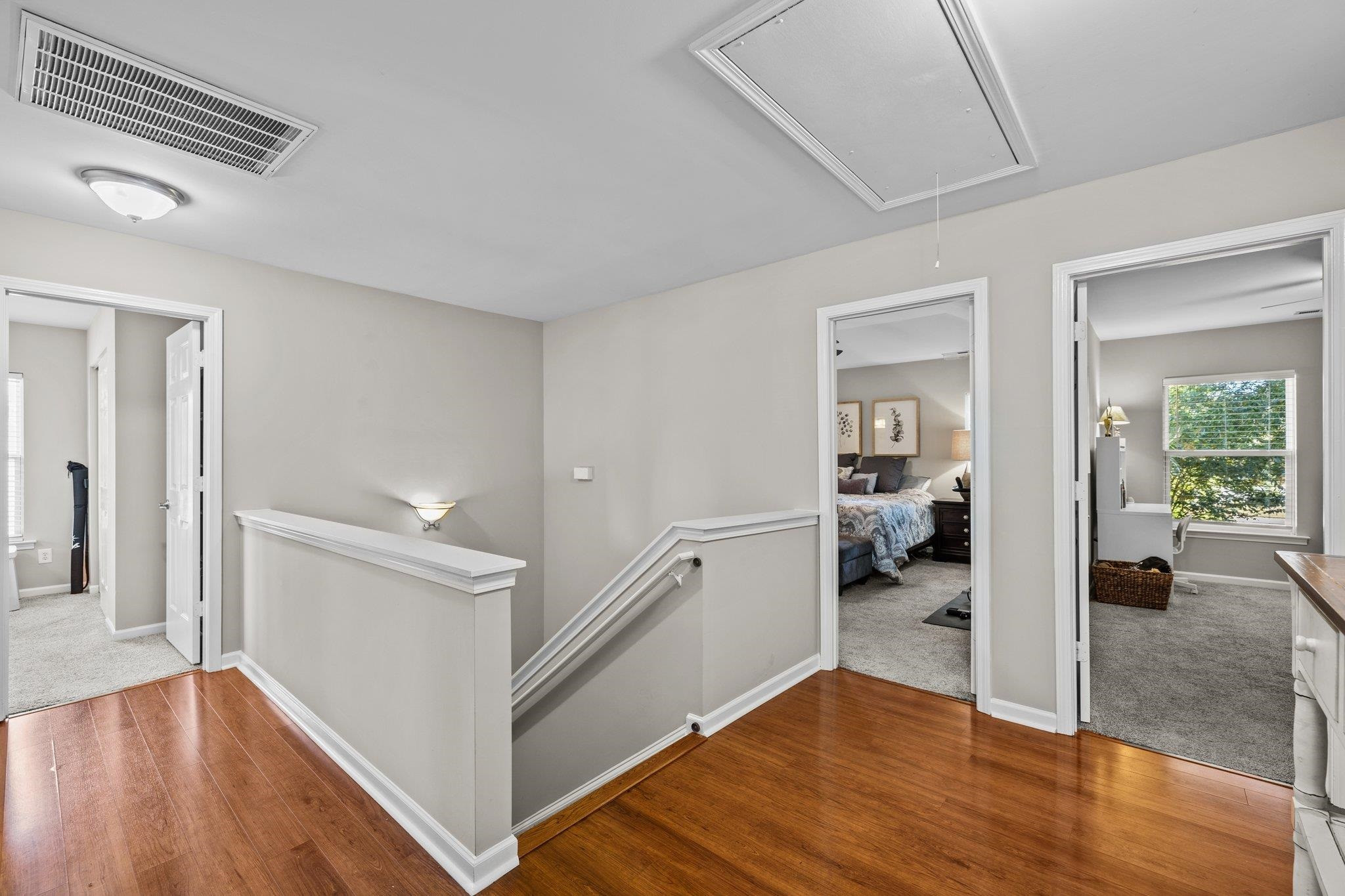 180 Solheim Lane Raleigh, NC 27603 - Photo 21 of 39 a view of a hallway with wooden floor and a living room