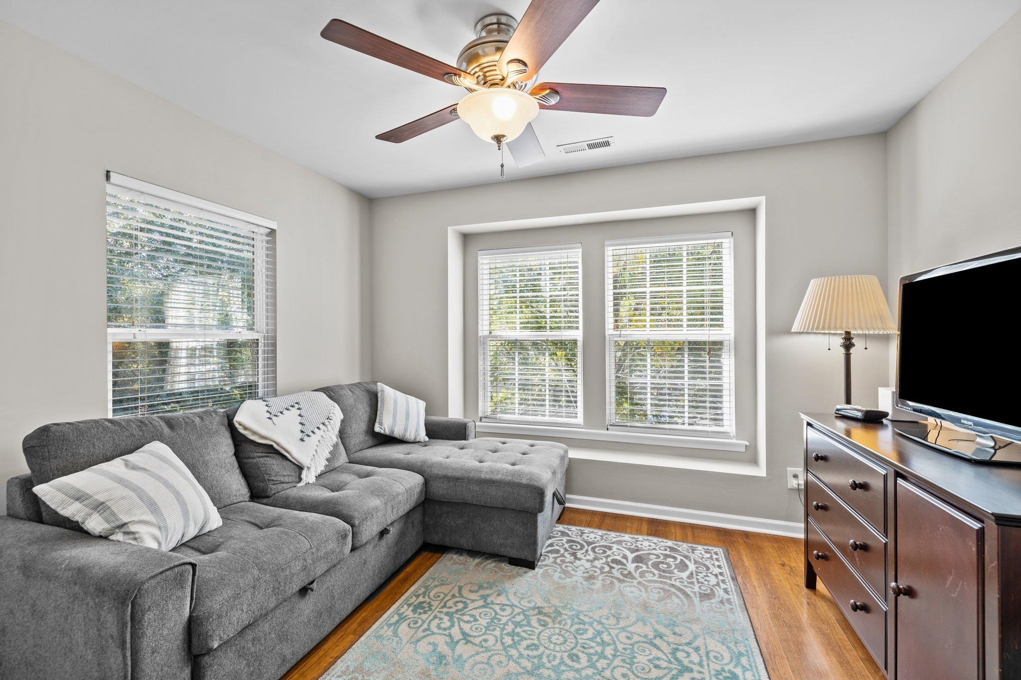 180 Solheim Lane Raleigh, NC 27603 - Photo 26 of 39 a living room with furniture and a flat screen tv
