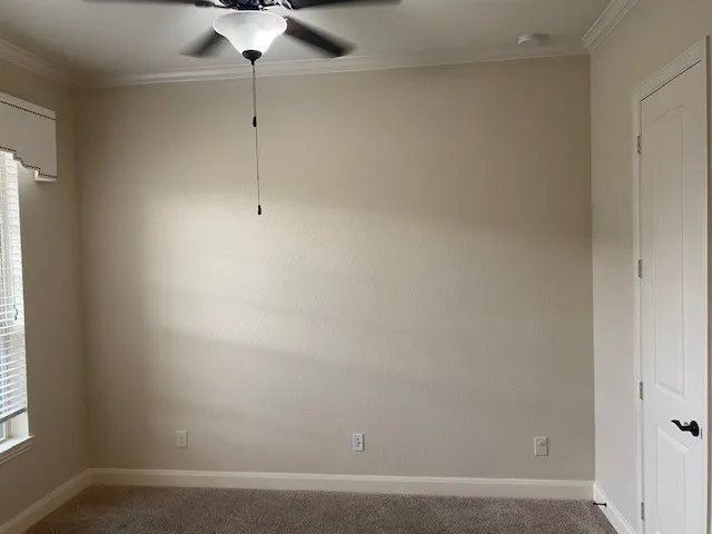 a room with a fan and a window