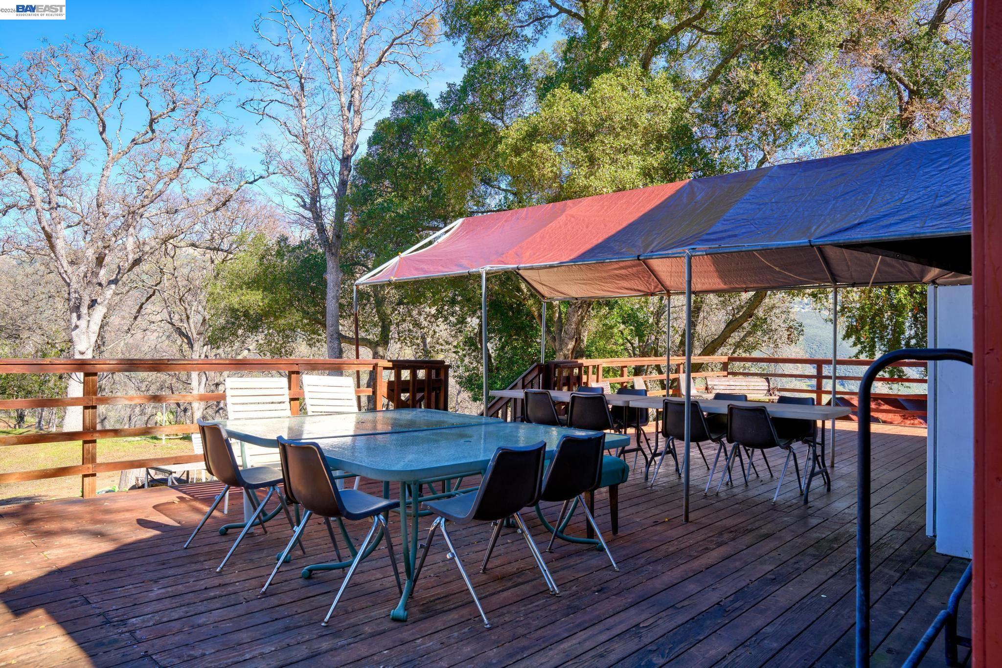 7777 Del Valle Road Livermore, CA 94550 - Photo 11 of 60 a view of a patio with table and chairs under an umbrella with wooden floor