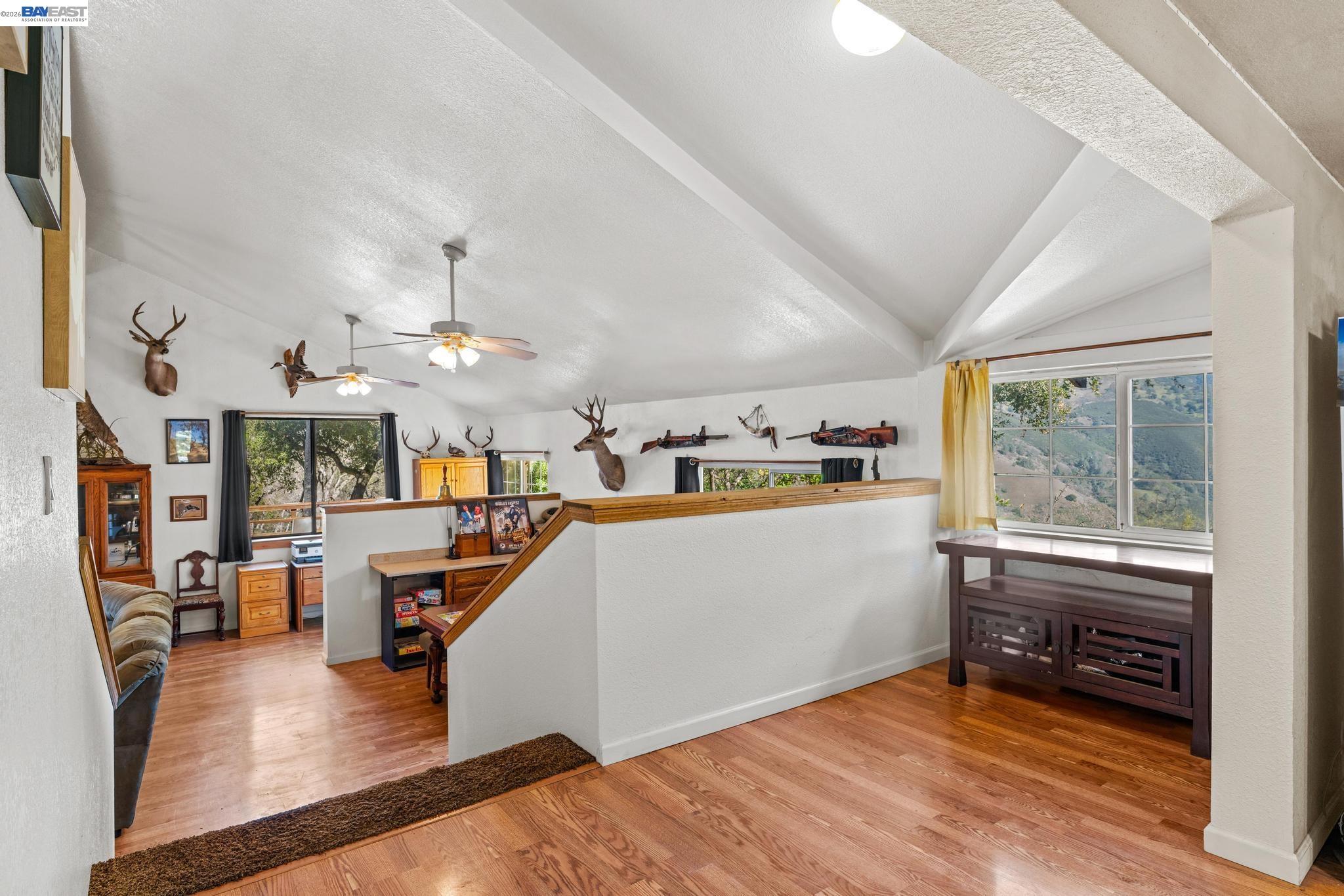 7777 Del Valle Road Livermore, CA 94550 - Photo 21 of 60 a view of a living room and kitchen with furniture wooden floor and a window