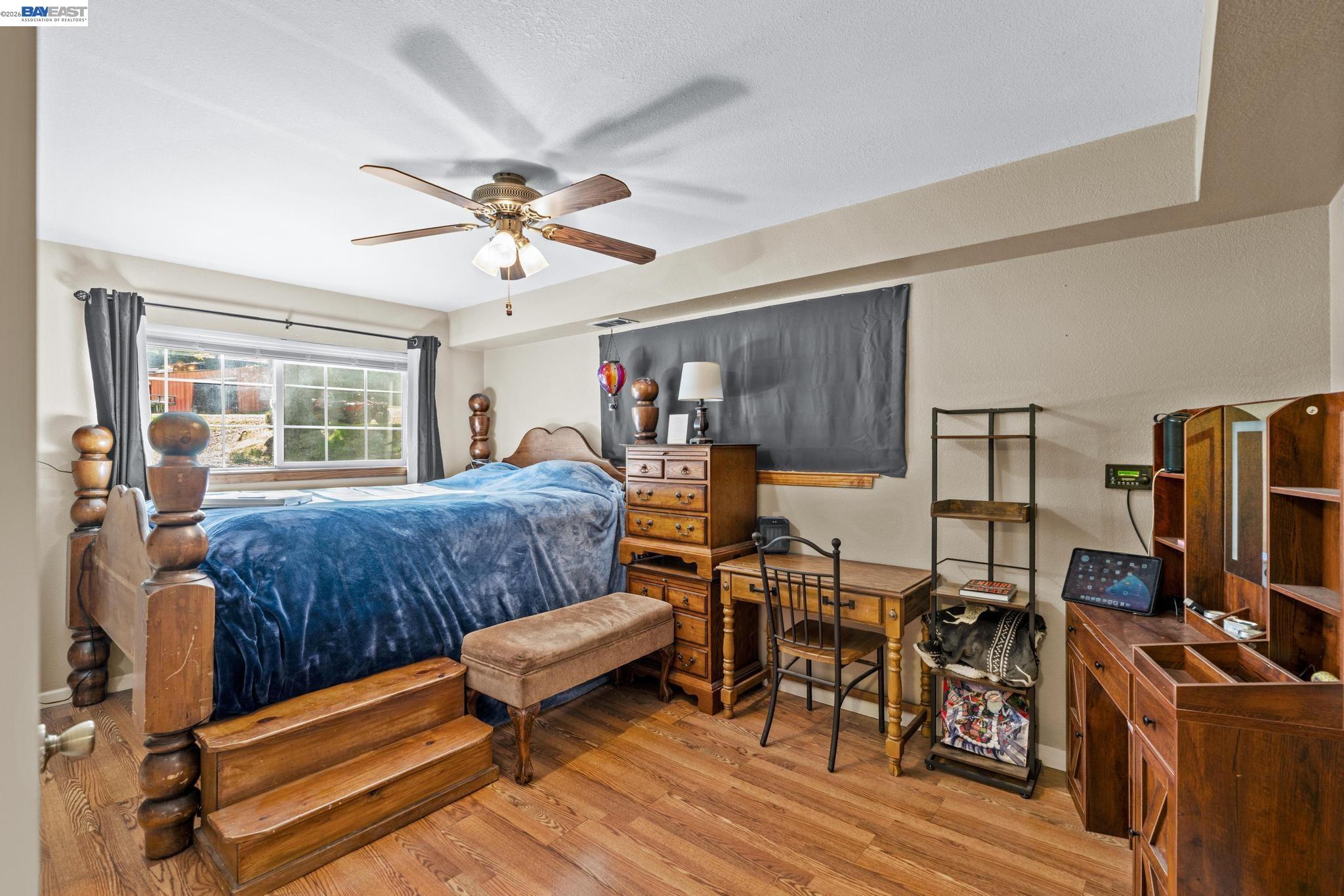 7777 Del Valle Road Livermore, CA 94550 - Photo 27 of 60 a living room with furniture a ceiling fan a lamp and a window