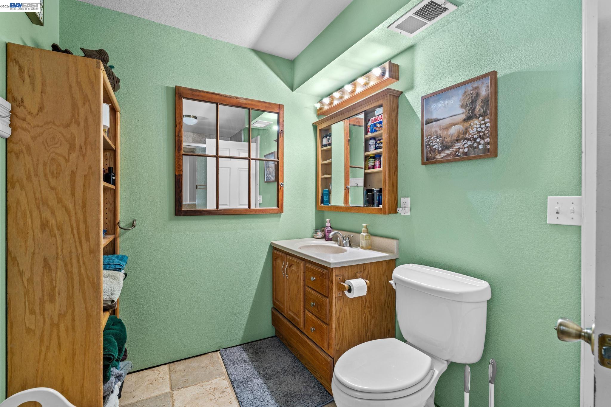 7777 Del Valle Road Livermore, CA 94550 - Photo 31 of 60 a bathroom with a toilet sink and mirror