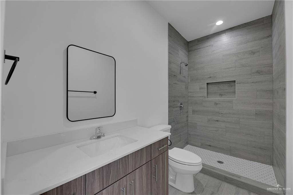 2509 Mockingbird Road, Unit B Weslaco, TX 78596 - Photo 10 of 11 Bathroom featuring vanity, toilet, and tiled shower