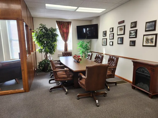 a view of a dining room with furniture and a potted plant
