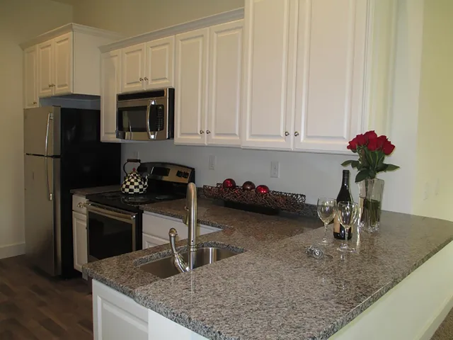 a kitchen with a sink a microwave and cabinets