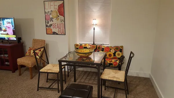 a dining room with furniture and wooden floor