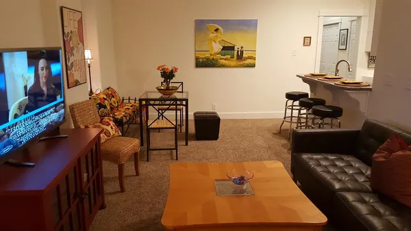 a living room with furniture rug and lamp