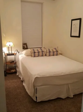 a bedroom with a bed and window