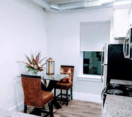 a dining room with furniture and wooden floor