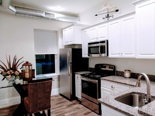 a kitchen with a microwave a stove and refrigerator