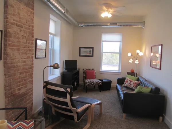 a living room with furniture and a window