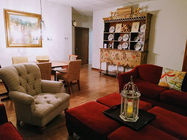 a living room with furniture and a wooden floor