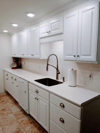 a kitchen with cabinets appliances and a sink