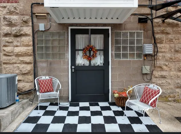 a black and white checkered floor with a rug