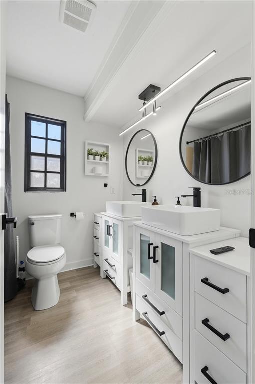 669 Eagle Run Lakeland, FL 33809 - Photo 21 of 69 a bathroom with a toilet a sink and a mirror
