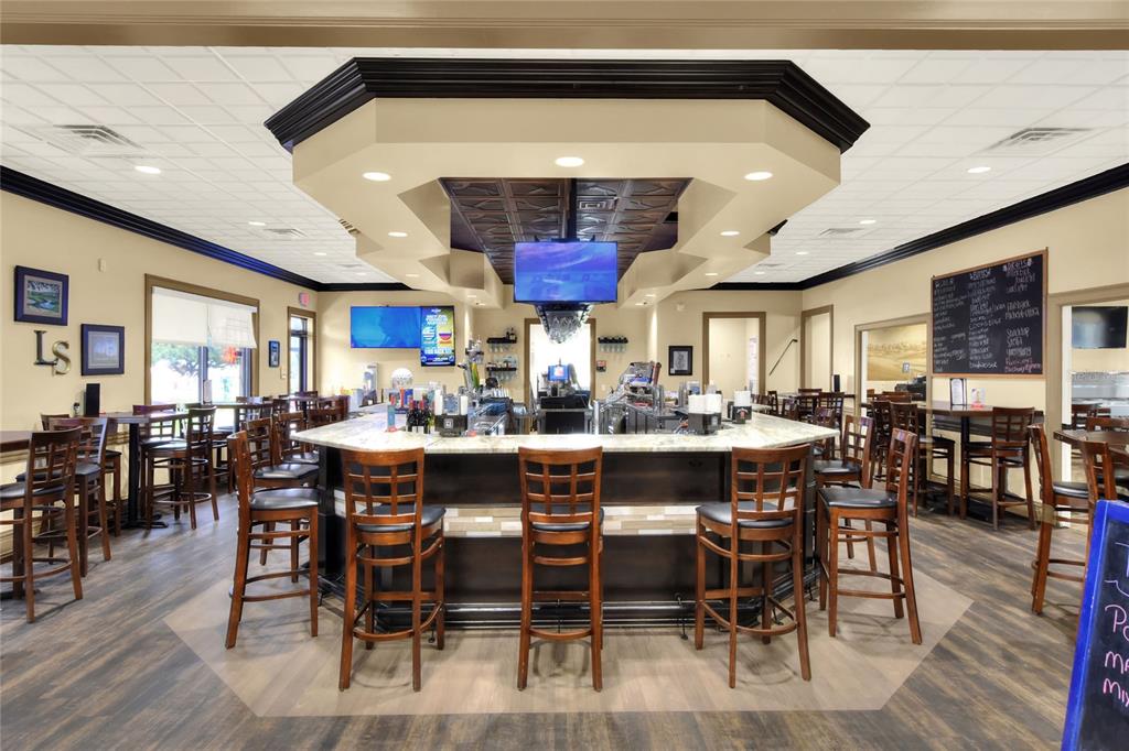 669 Eagle Run Lakeland, FL 33809 - Photo 54 of 69 a dining hall with stainless steel appliances a dining table and chairs with wooden floor