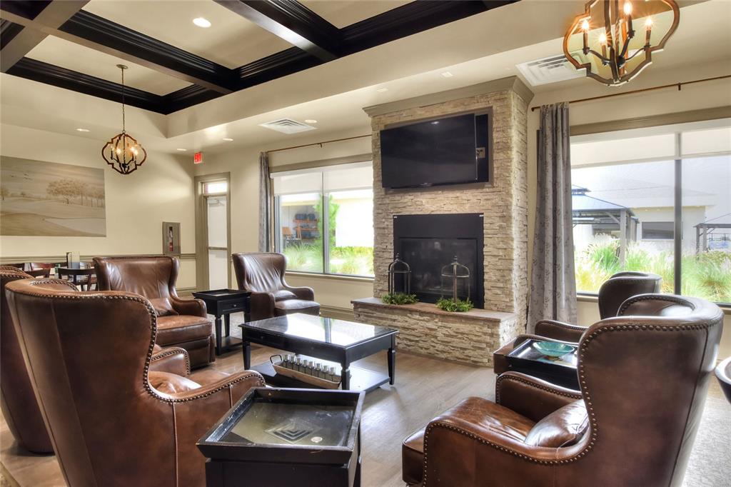 669 Eagle Run Lakeland, FL 33809 - Photo 56 of 69 a living room with furniture chandelier and a fireplace