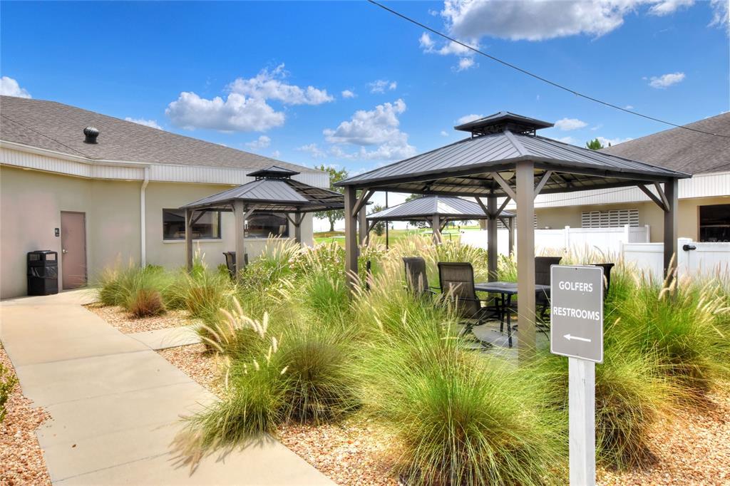 669 Eagle Run Lakeland, FL 33809 - Photo 60 of 69 a view of a porch with a table and chairs under an umbrella