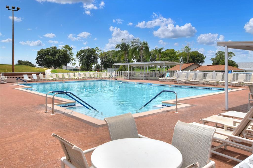 669 Eagle Run Lakeland, FL 33809 - Photo 63 of 69 a view of a swimming pool with a lounge chairs
