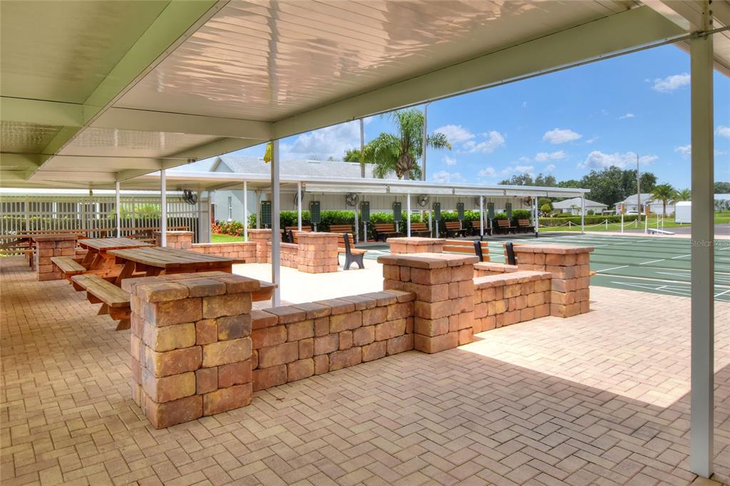 669 Eagle Run Lakeland, FL 33809 - Photo 68 of 69 a view of a patio with a dining table and chairs