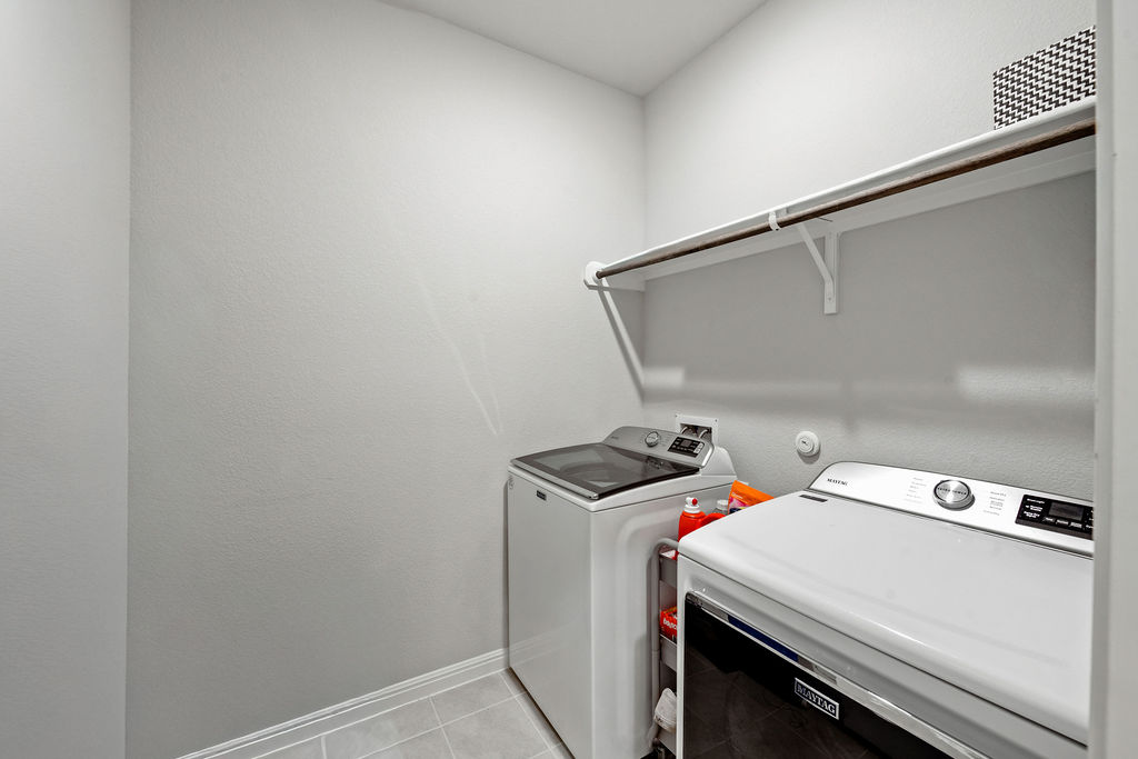 2417 Roosevelt Road Leander, TX 78641 - Photo 21 of 40 Laundry room featuring separate washer and dryer and light tile patterned flooring