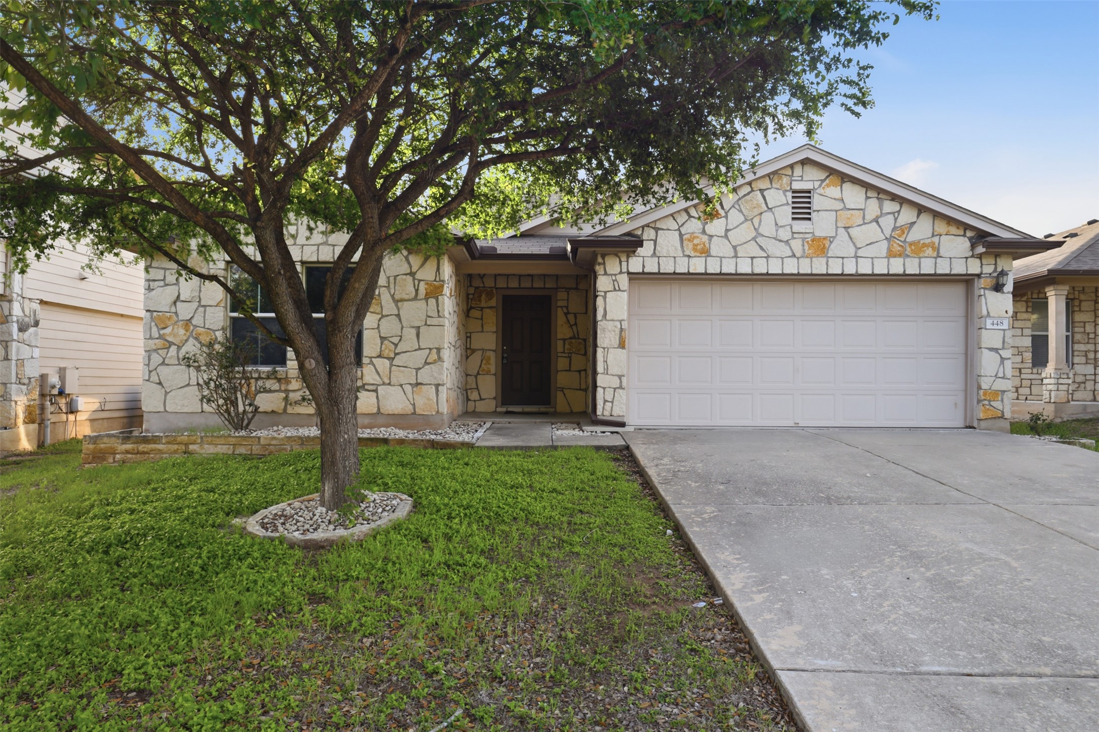 448 Nottingham Loop Kyle, TX 78640 - Photo 1 of 16 Stone veneer exterior with a two-car garage