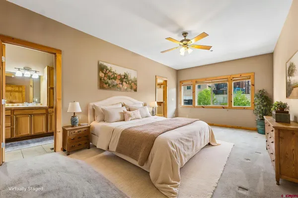 a spacious bedroom with a large bed and a window