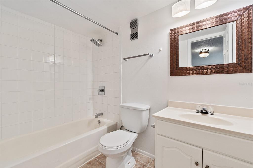 916 Lake Destiny Road, Unit E Altamonte Springs, FL 32714 - Photo 14 of 26 a bathroom with a sink toilet a mirror and shower