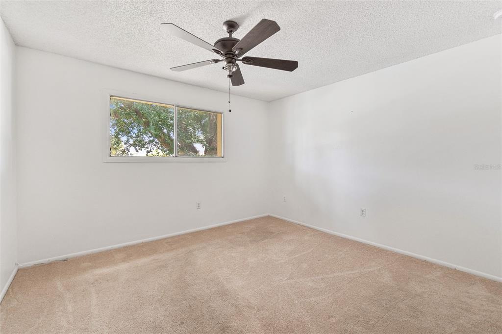 916 Lake Destiny Road, Unit E Altamonte Springs, FL 32714 - Photo 18 of 26 an empty room with a window and a fan