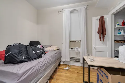 a bed room with a bed and a desk